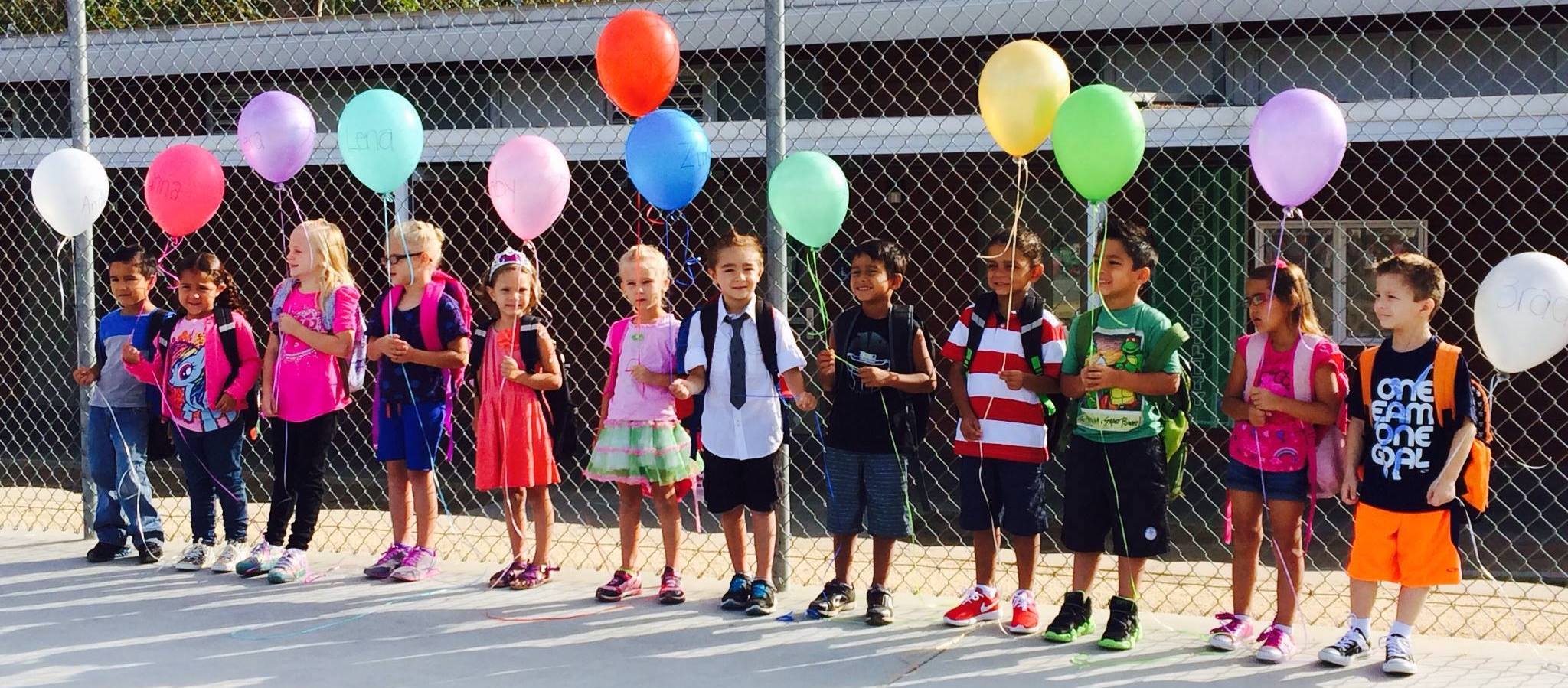 Kids holding colorful ballons